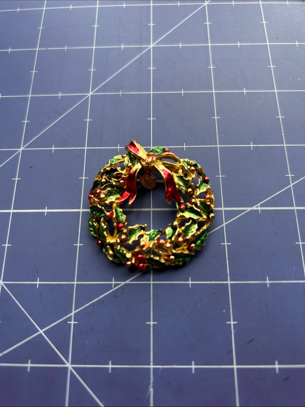 Virgin Mary charm on holiday wreath brooch painted goldtone metal holly leaves